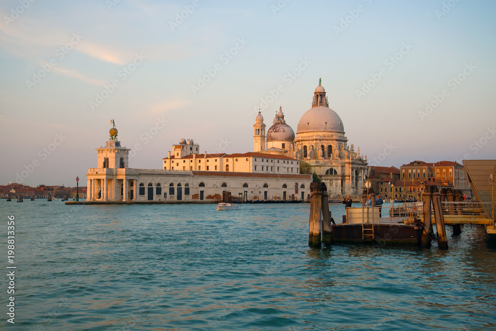 View of the ancient building of city customs of Dogana-di-Mar and cathedral of Santa-Maria-della-Salyute early in the morning. Venice, Italy