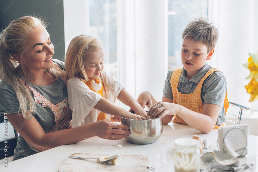 Mom cooking with kids on the kitchen Mom cooking with kids on the kitchen