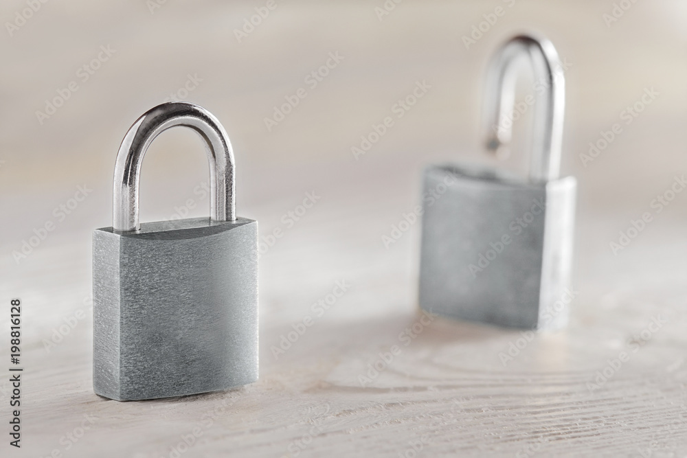 Fototapeta premium estate concept with symbol of security, lock padlock with key on wooden background.