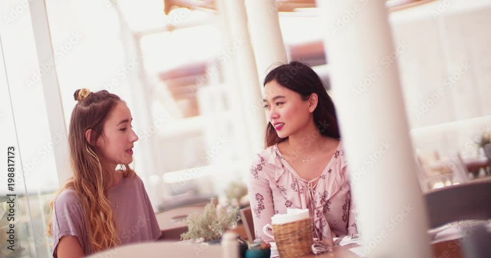 Beautiful multi-ethnic women sitting and talking in Greek island restaurant Beautiful multi-ethnic women sitting and talking in Greek island restaurant