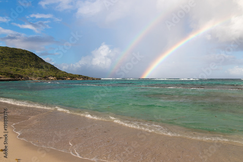 Double rainbow over Anse à l'Eau (translation: Water Cove) - beautiful cove with turquoise water in Guadeloupe, Caribbean