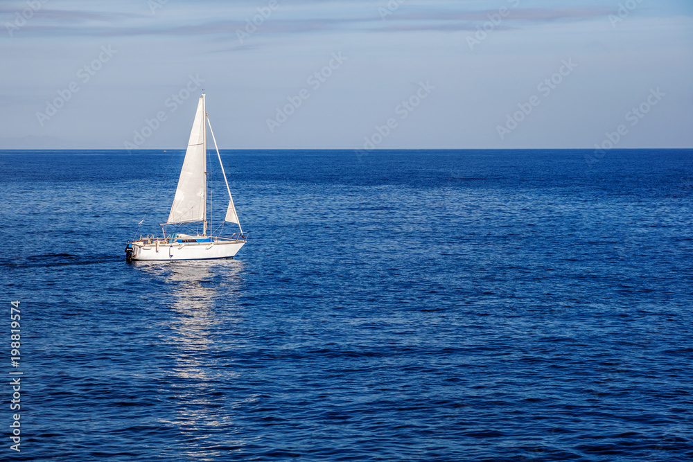 Beautiful seascape, white sailboat in the blue sea, romance of travel, summer vacation, sailing