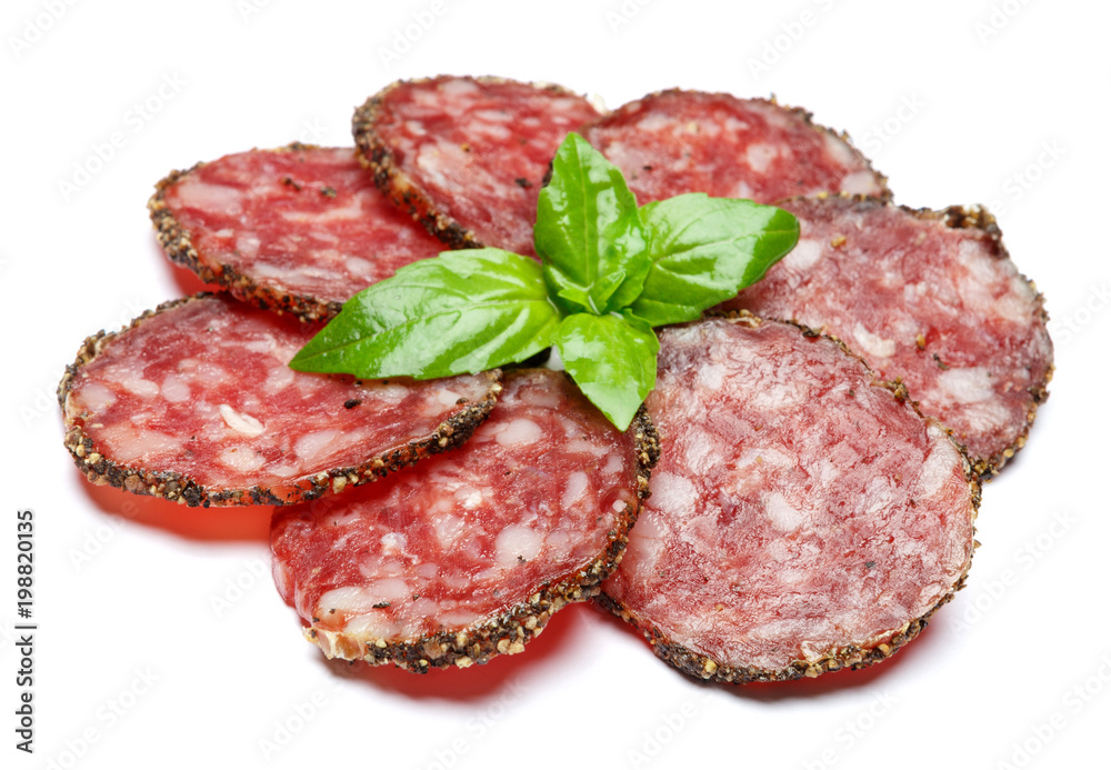Dried organic salami sausage covered with pepper on white background