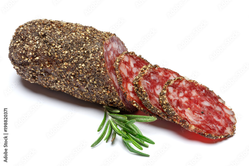 Dried organic salami sausage covered with pepper on white background