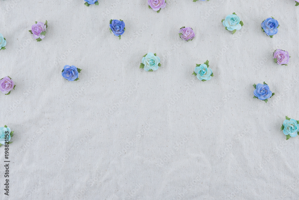 Blue tone rose paper flowers pattern on muslin fabric with copy space Blue tone rose paper flowers pattern on muslin fabric with copy space