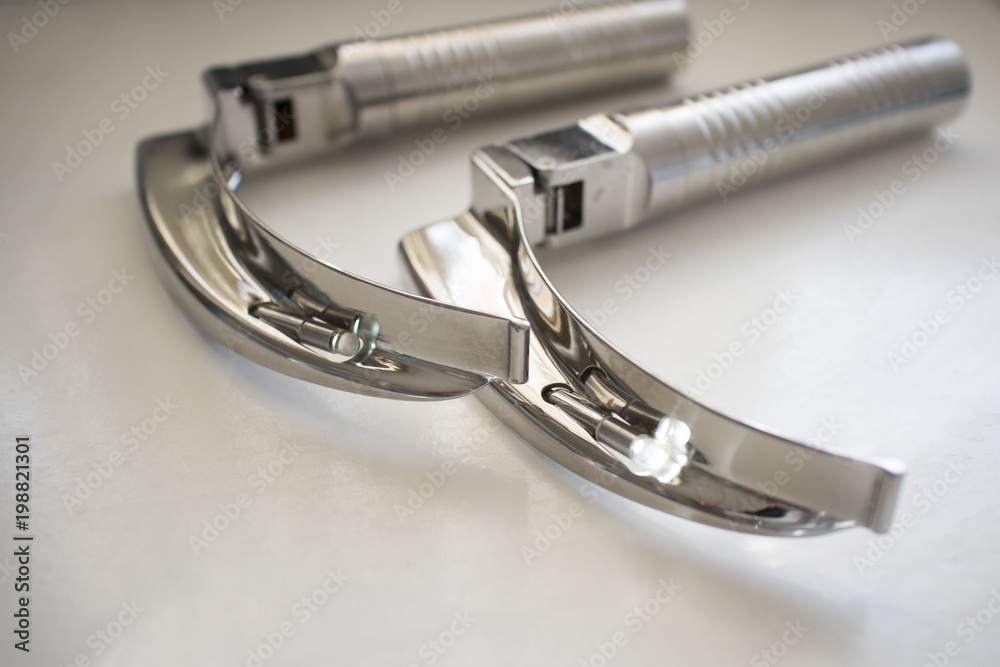 Laryngoscope in hospital operating room, on the medical table Laryngoscope in hospital operating room, on the medical table