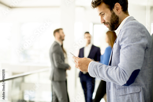 Handsome young businessman with mobile phone
