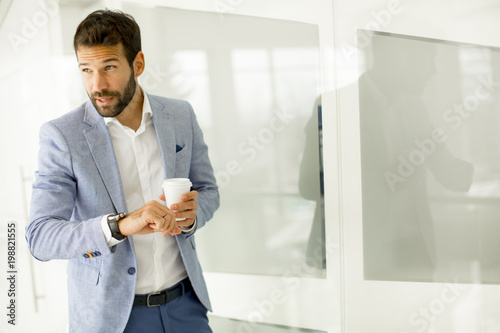 Young business man drinking...