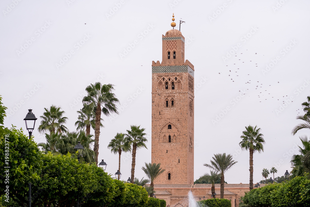 View of the Koutoubia Mosque in Marrakesh with palm trees in the foreground