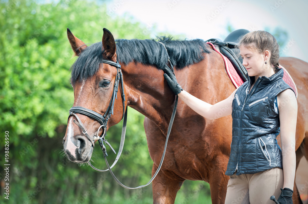 Young teenage girl tenderly looking at her favorite red horse Young teenage girl tenderly looking at her favorite red horse