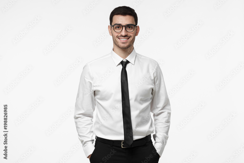 Fototapeta premium Portrait of young salesman, happy positive manager, isolated on grey background