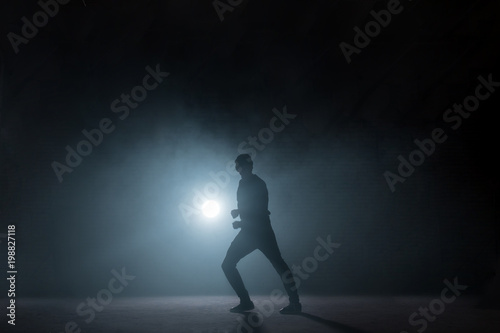 dancer showing his skills on black background. dancing at darkness. sporty lifestyle. hobby.favourite deal