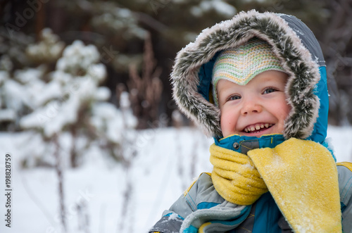 Little boy playing with snow and spade photo