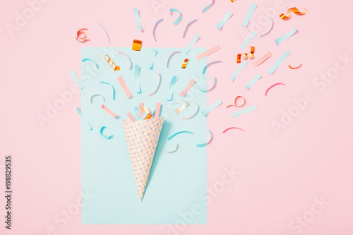 birthday hat with confetti on paper background
