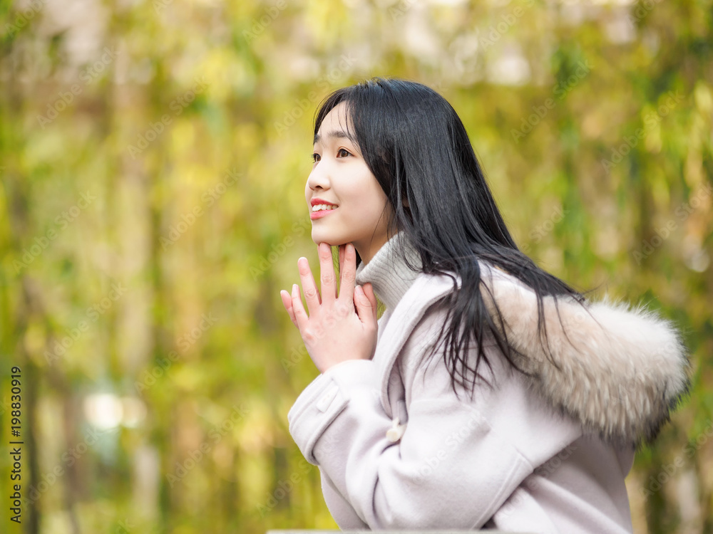 Portrait of beautiful young brunette woman in white winter coat. Outdoor fashion portrait of glamour young Chinese teenage stylish lady. Emotions, people, beauty and lifestyle concept. Portrait of beautiful young brunette woman in white winter coat. Outdoor fashion portrait of glamour young Chinese teenage stylish lady. Emotions, people, beauty and lifestyle concept.