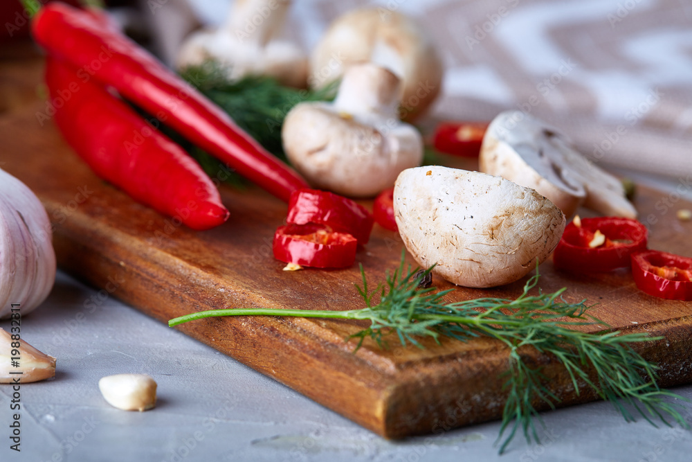 Vegetables on cutting board, plate with salt over white textured background, close-up, selective focus. Vegetables on cutting board, plate with salt over white textured background, close-up, selective focus.