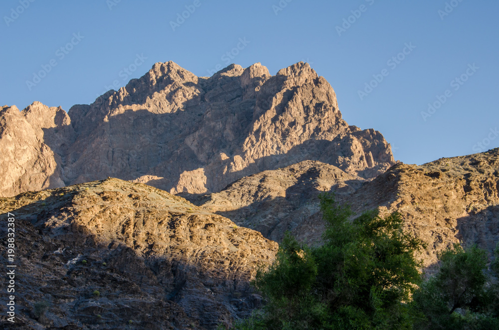Large rocky mountains in Oman during sunset