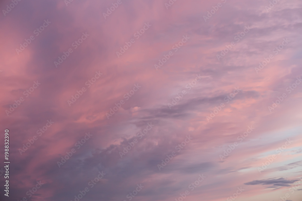 Multi-colored clouds on sky at sunset.