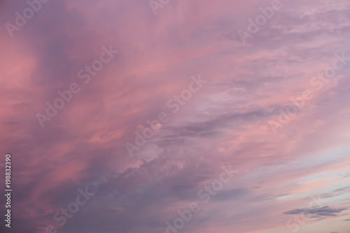 Multi-colored clouds on sky at sunset. © Yuri Bizgaimer
