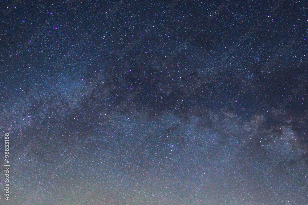 Obraz premium Starry night sky, Milky way galaxy with stars and space dust in the universe, Long exposure photograph, with grain.