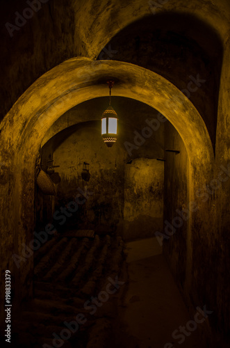 Cellar in Omani fort with lamp on ceiling