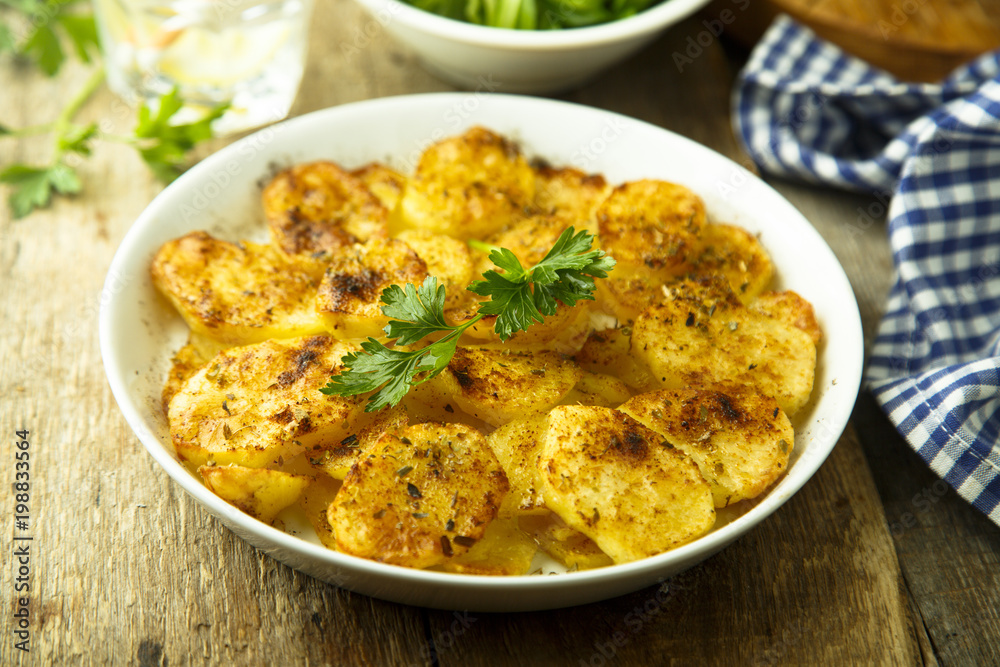 Homemade potato gratin with cheese and herbs Homemade potato gratin with cheese and herbs