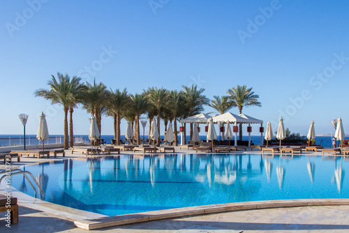 View on the calm deep blue water of the swimming pool with reflextion in Sharm El Sheikh resort