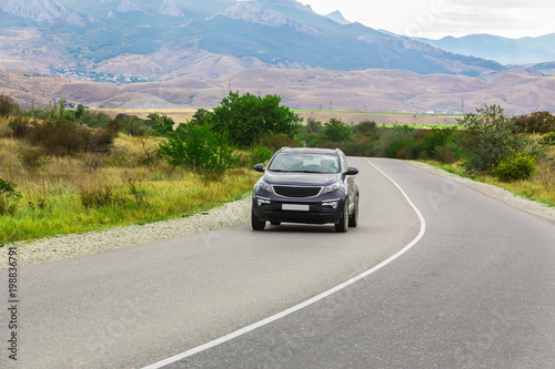 landscape with mountains, lake, road and car