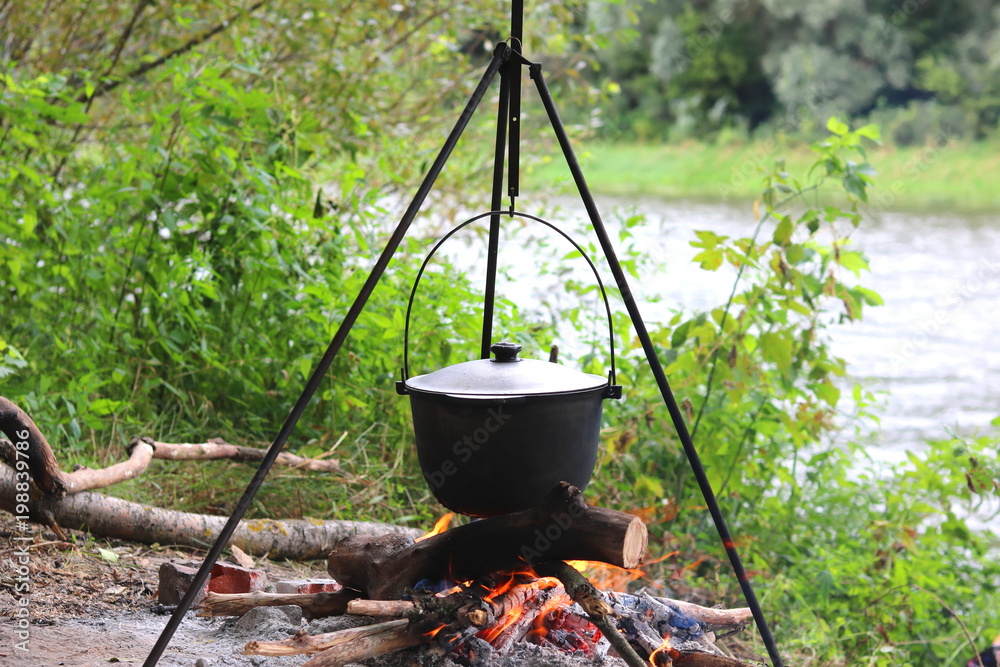 Cooking food on campfire in spring on picnic Cooking food on campfire in spring on picnic