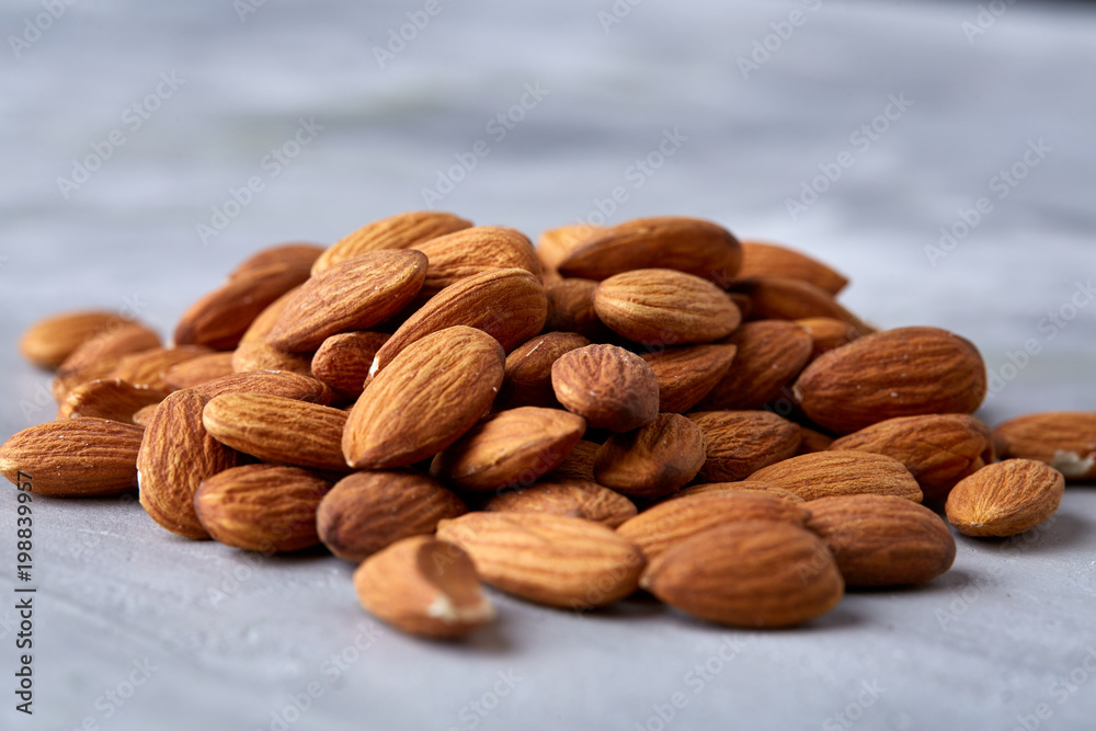 Seamless pattern with almond on the gray background, flat lay, close-up. Seamless pattern with almond on the gray background, flat lay, close-up.