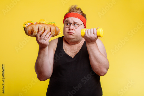 Fat funny man choise between sport and fastfood