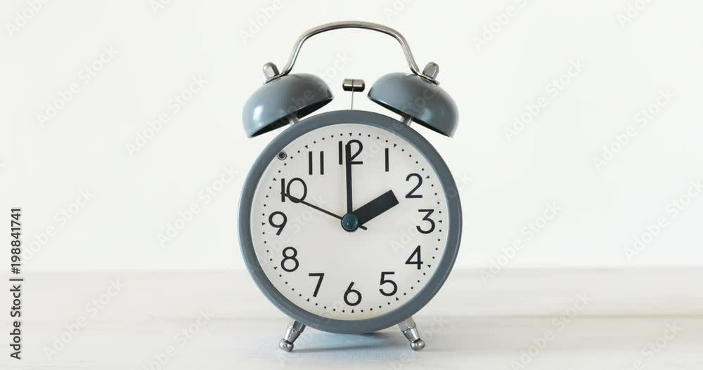traditional alarm clock on white table , Time running concept , 4K Dci resolution