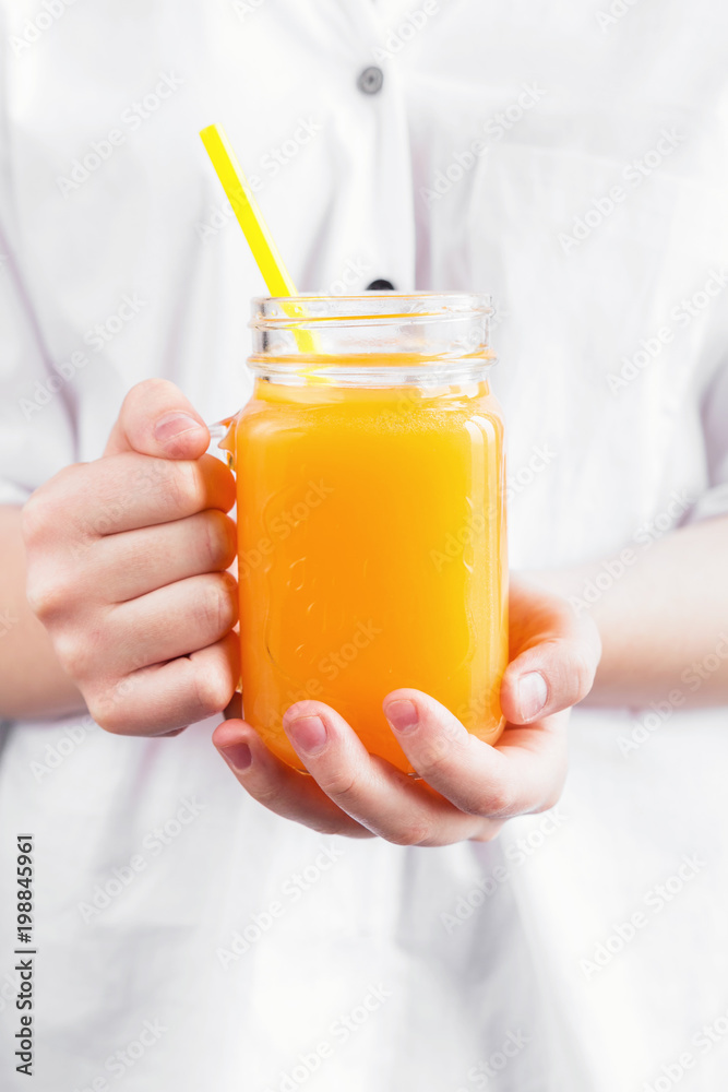 Girl child holding a jar of orange juice, concept of health Girl child holding a jar of orange juice, concept of health
