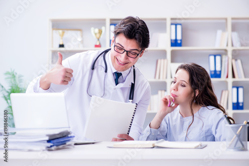 Female patient visiting male doctor for regular check-up in hosp