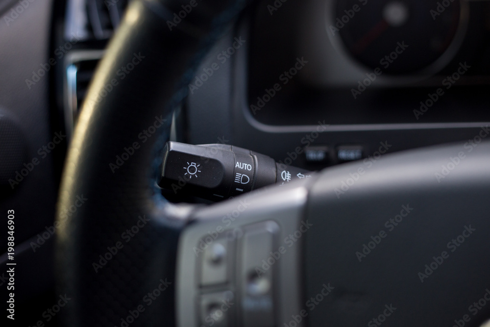 Close up of light switch in a car steering.