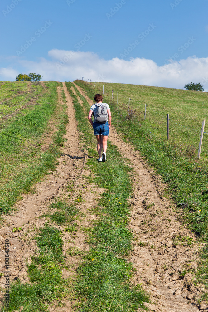 Woman hiking on summer hill near Liptovsky Trnovec, Slovakia.