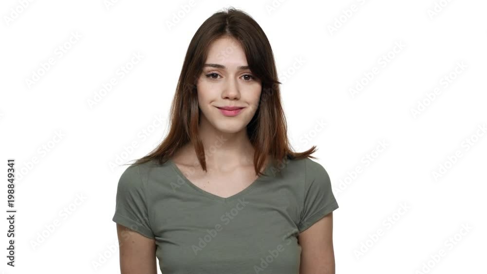 Portrait of brunette woman 20s wearing casual t-shirt laughing out loud after listening funny joke, isolated over white background in studio. Concept of emotions Portrait of brunette woman 20s wearing casual t-shirt laughing out loud after listening funny joke, isolated over white background in studio. Concept of emotions