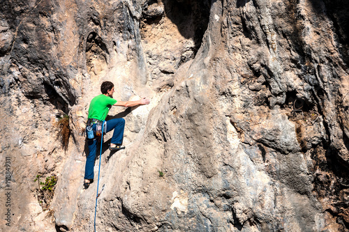 A man climbs the rock. © zhukovvvlad