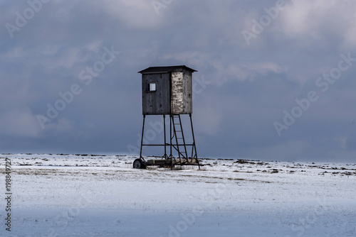 hunter posing on roller coasters in a snowy field in winter