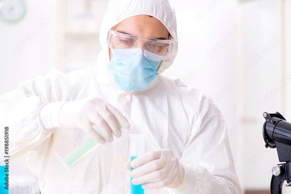 Young chemist student working in lab on chemicals Young chemist student working in lab on chemicals