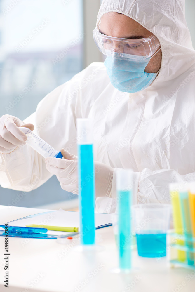 Young chemist student working in lab on chemicals Young chemist student working in lab on chemicals