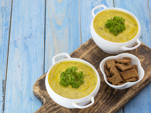 pumpkin puree soup on a wooden table.  photo