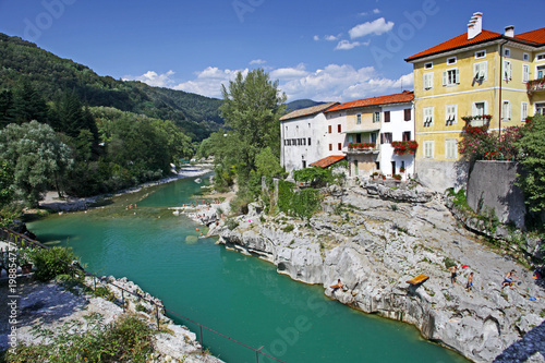 Beautiful rive Soca and ancient buildings in small  town Kanal, Slovenia photo