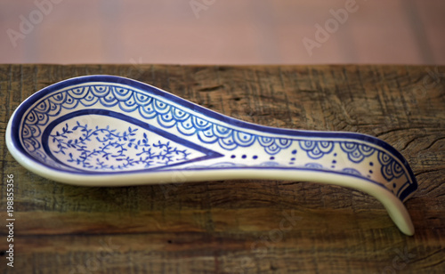 Silver spoon in earthenware holder