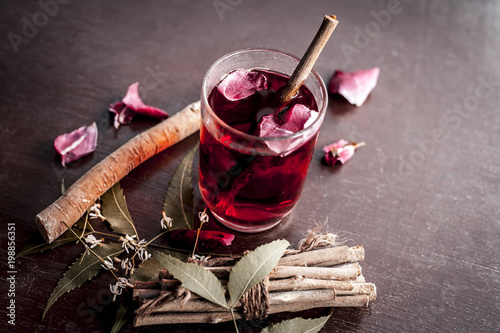 Indian Ayurvedic and Islamic way of doing brush with using miswak or Neem bark with rose water on wooden surface in dark Gothic colors. photo