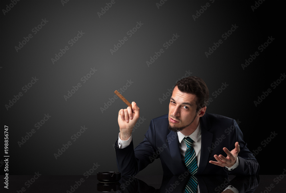 Businessman holding cigarette in his hand and wearing suit. Businessman holding cigarette in his hand and wearing suit.