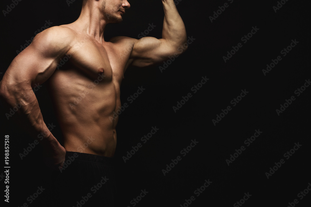 Strong athletic man showes naked muscular body Strong athletic man showes naked muscular body