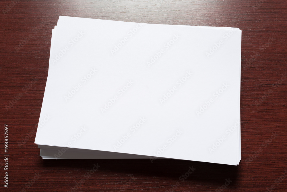 White business card on wooden table. Blank portrait A4. White business card on wooden table. Blank portrait A4.