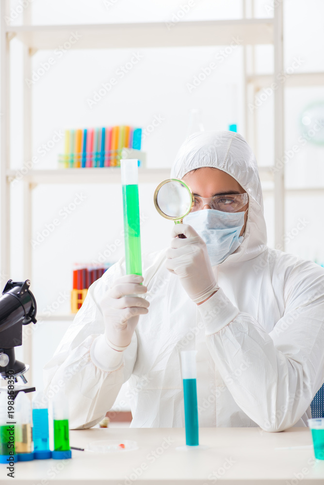 Young chemist student working in lab on chemicals Young chemist student working in lab on chemicals