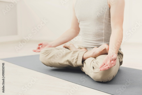 Young man in yoga class, relax meditation pose
